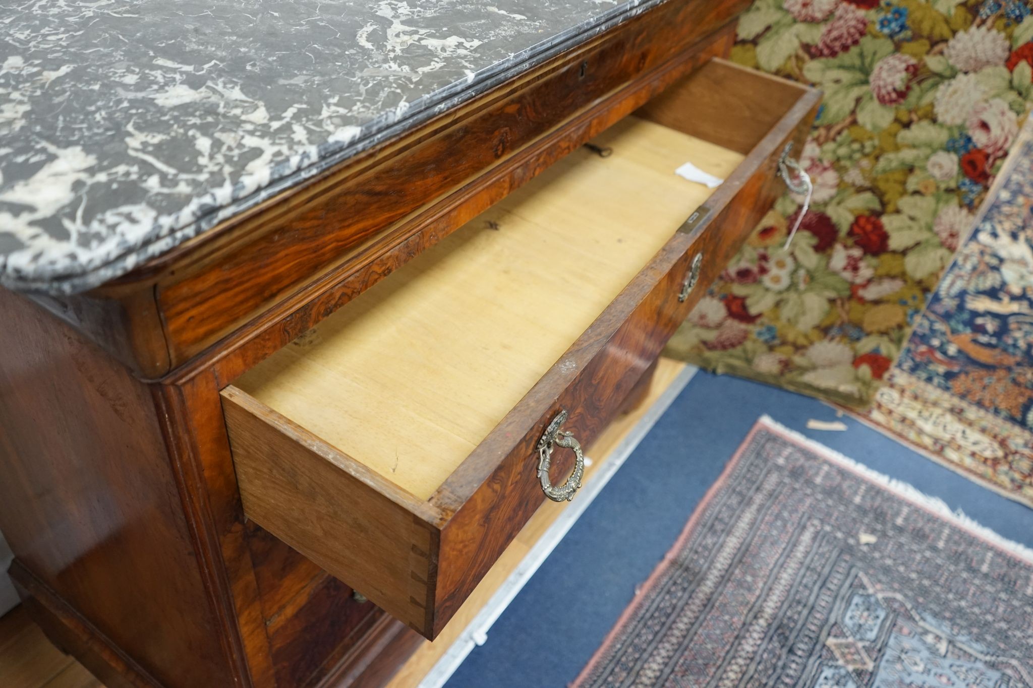 A 19th century French marble top walnut commode, width 129cm, depth 60cm, height 104cm